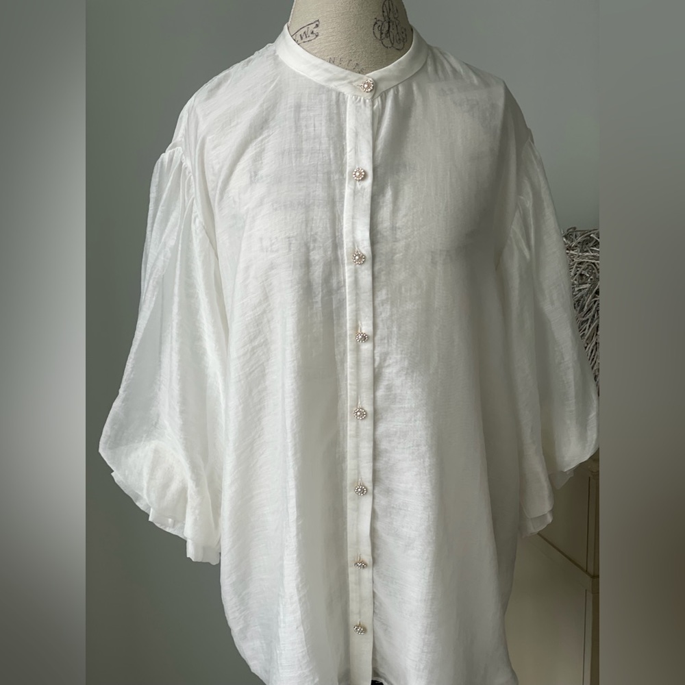 Cream blouse with decorative button detail